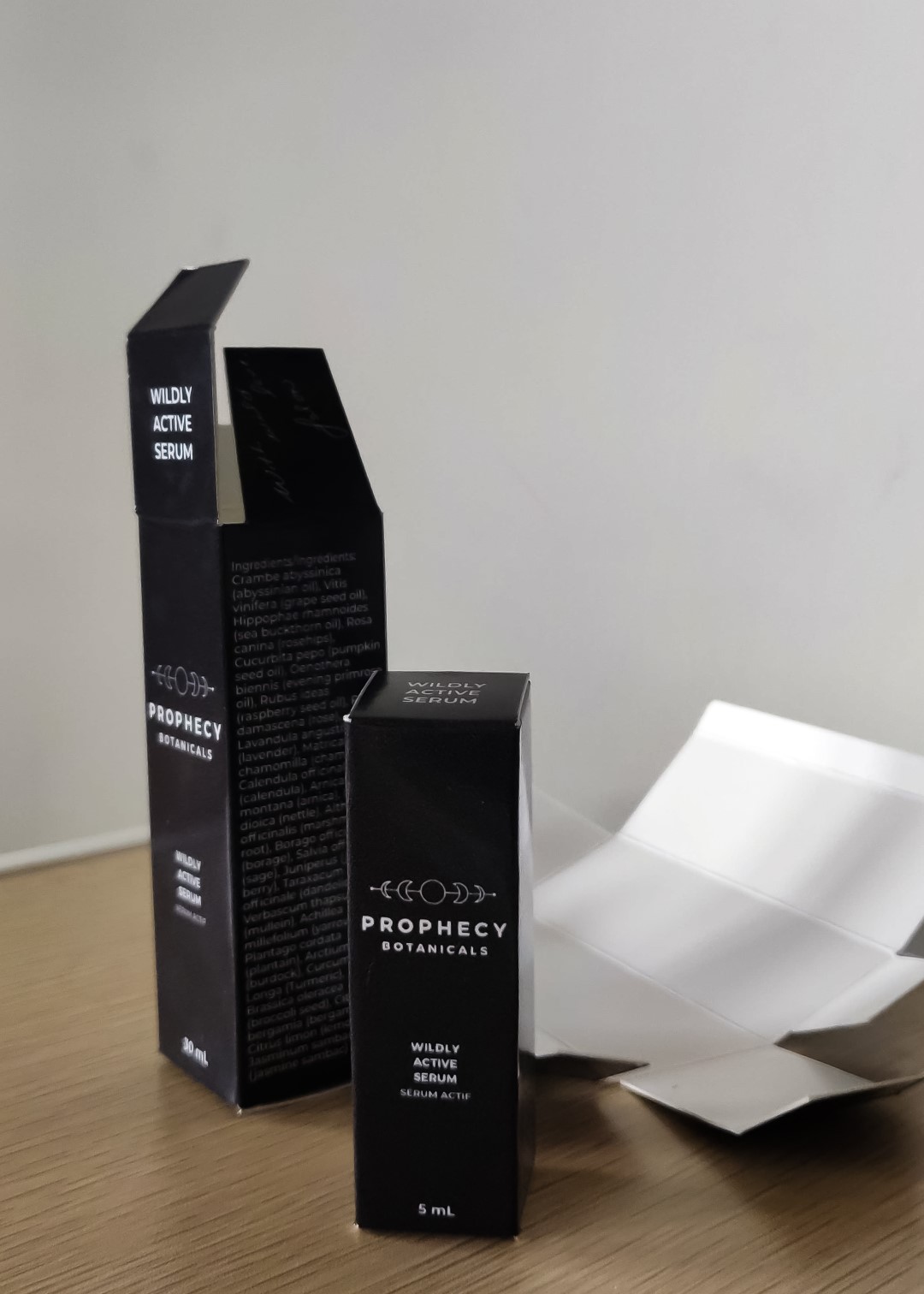 Posed shot of the final design for the two products I designed the packaging for. On the top, there is text to help know which product it is when stacked in a shelf space-saving manner. On the minor flap, there is a handwritten message from the brand owner